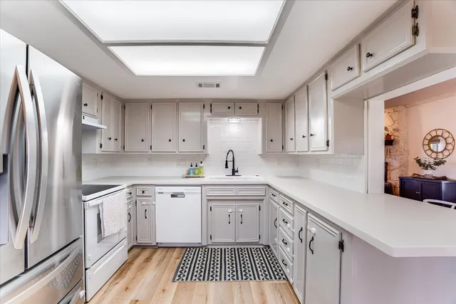 a kitchen with a sink stove and refrigerator