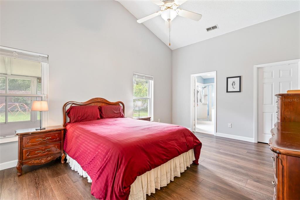 325 Longshadows Court Ocoee, FL 34761 - Photo 14 of 34 a bedroom with a bed and wooden floor