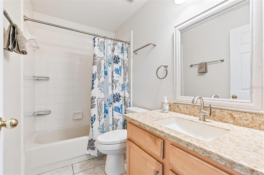 325 Longshadows Court Ocoee, FL 34761 - Photo 18 of 34 a bathroom with a granite countertop sink a toilet and shower