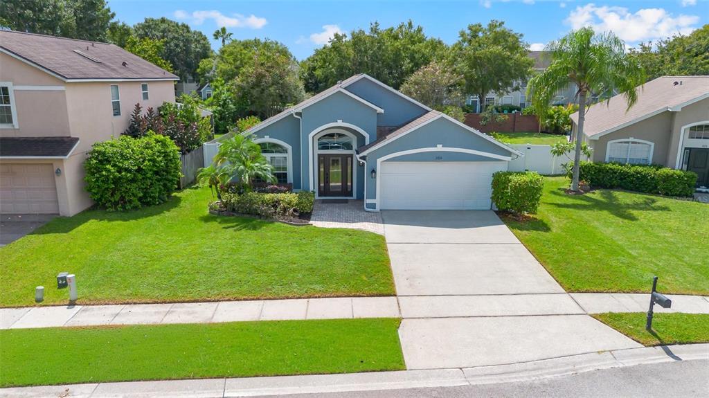 325 Longshadows Court Ocoee, FL 34761 - Photo 28 of 34 a front view of a house with garden