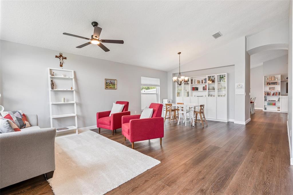 325 Longshadows Court Ocoee, FL 34761 - Photo 4 of 34 a living room with furniture and wooden floor
