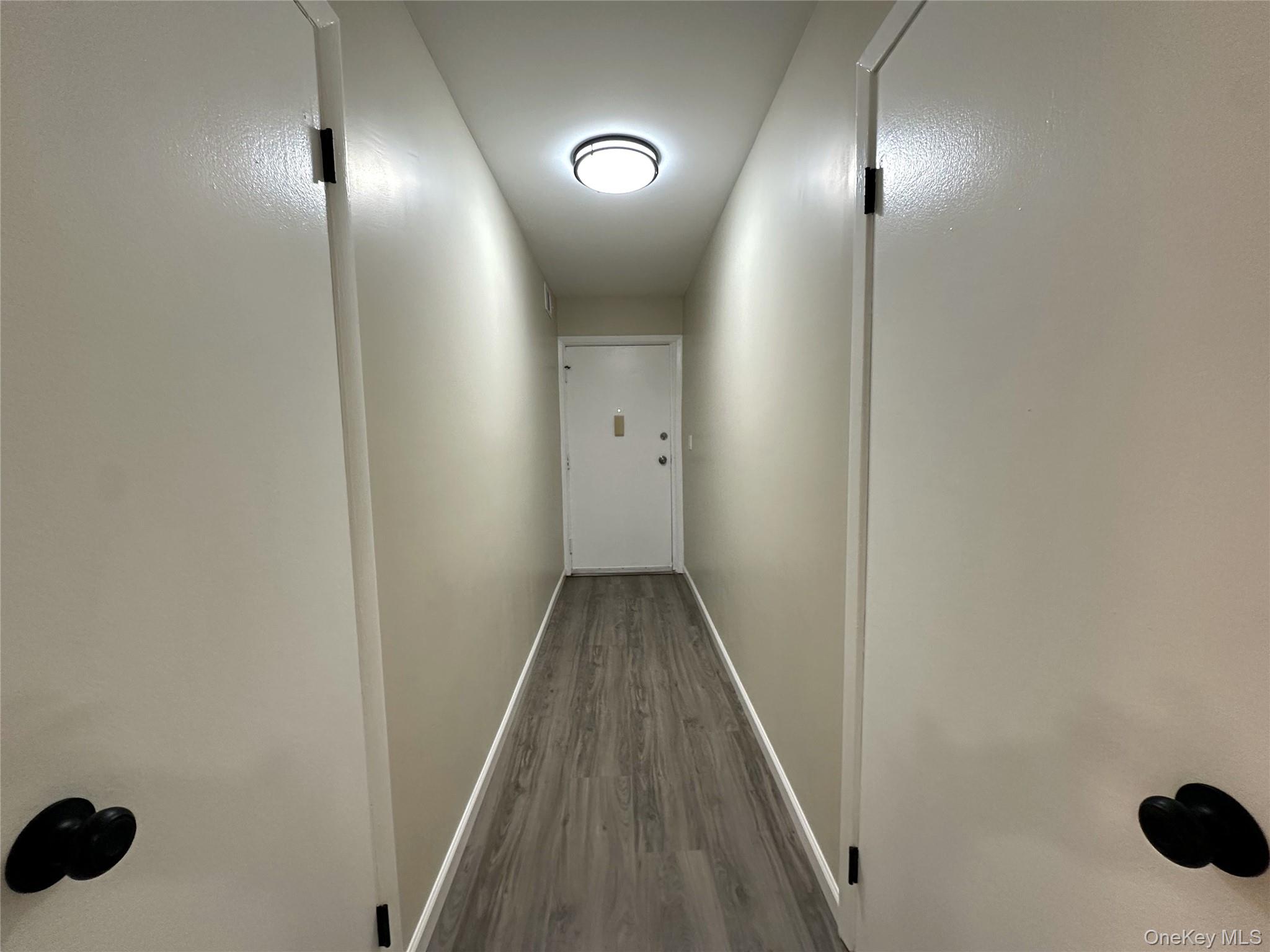 26 Cooper, Unit 511 Poughkeepsie, NY 12603 - Photo 12 of 15 a view of a hallway with wooden floor