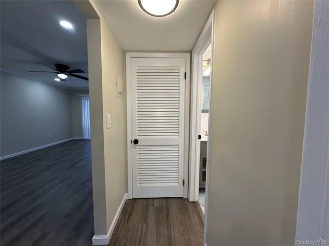 a view of a room with wooden floor and a window
