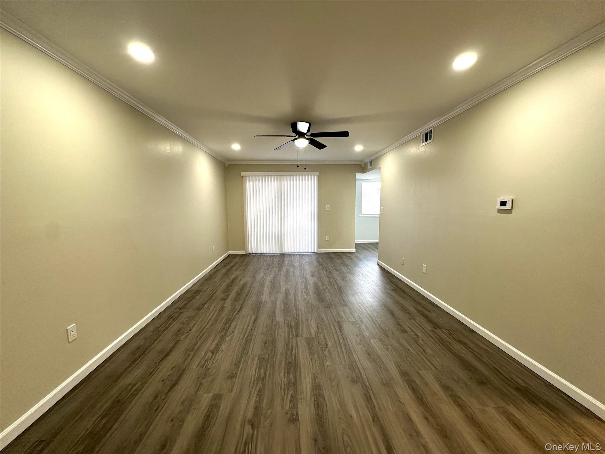 26 Cooper, Unit 511 Poughkeepsie, NY 12603 - Photo 5 of 15 an empty room with wooden floor and windows