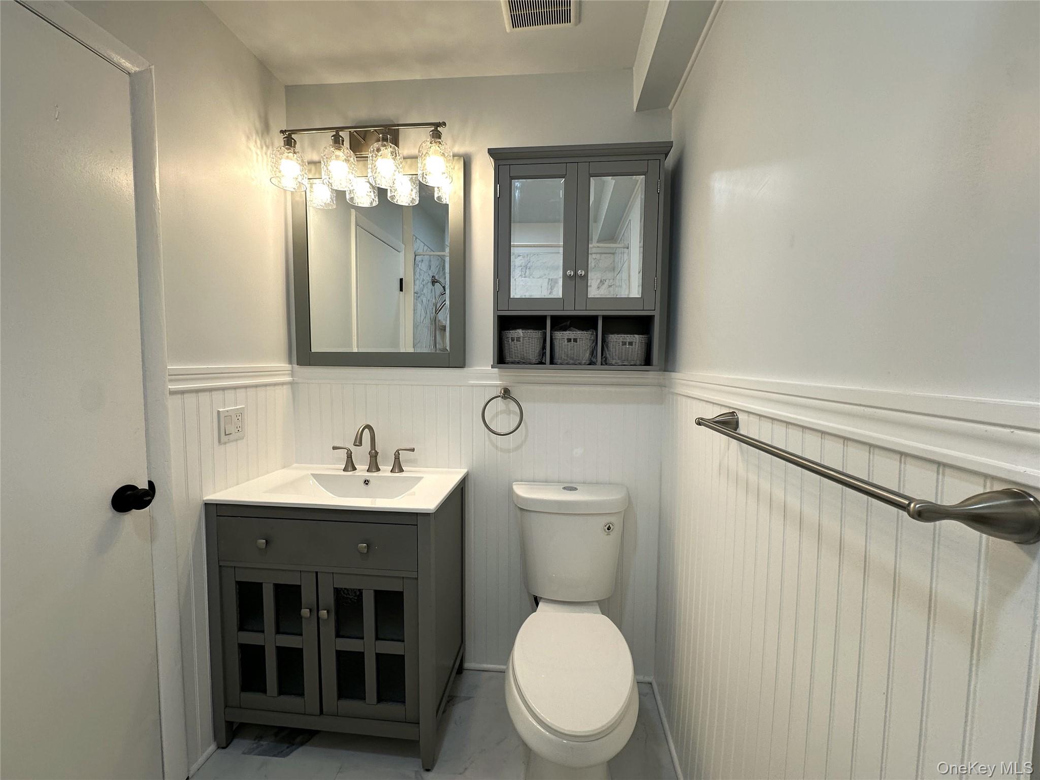 26 Cooper, Unit 511 Poughkeepsie, NY 12603 - Photo 6 of 15 a bathroom with a toilet a sink and mirror