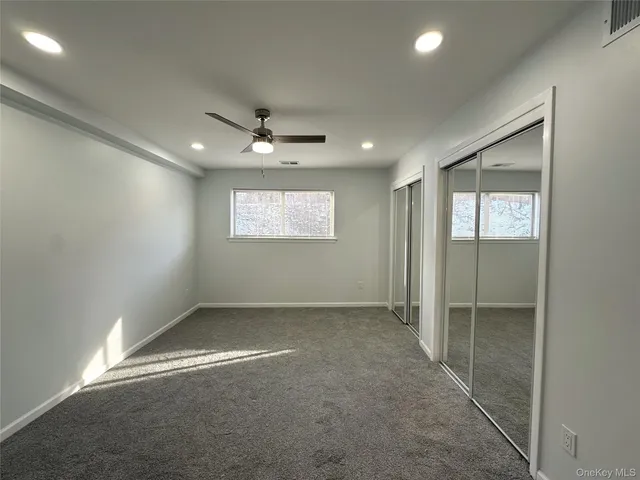a bathroom with a sink vanity mirror and toilet