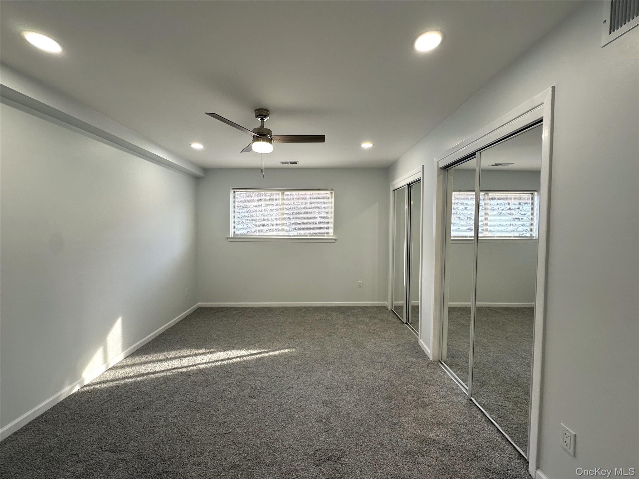 26 Cooper, Unit 511 Poughkeepsie, NY 12603 - Photo 9 of 15 an empty room with windows and closet