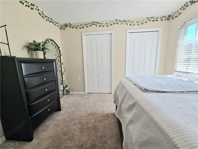 an empty room with a fan and a fan