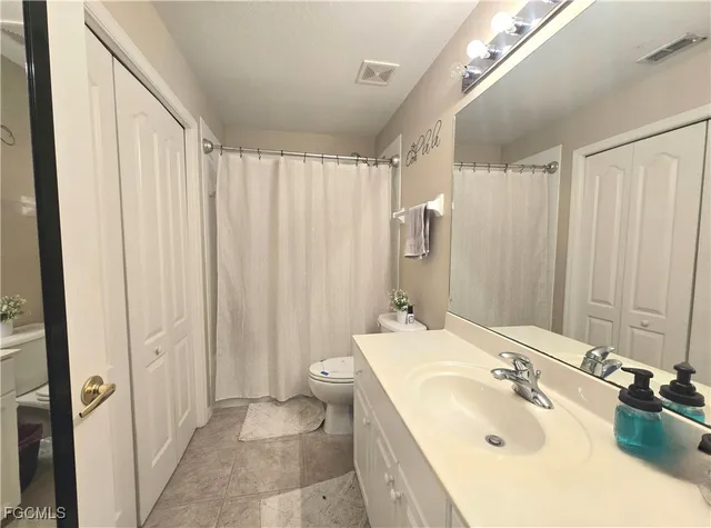 a balcony with furniture and potted plants