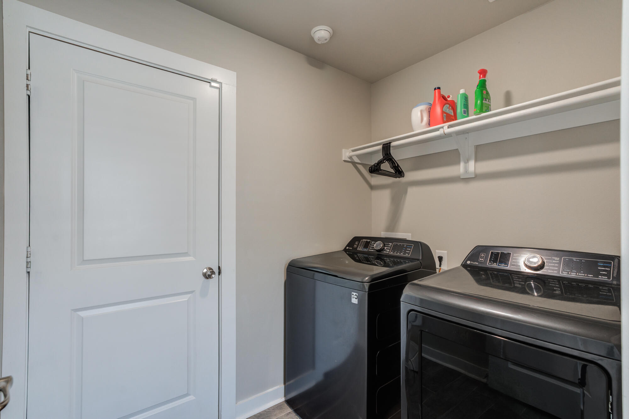 4613 126th Street Lubbock, TX 79424 - Photo 33 of 37 a utility room with dryer washer and empty racks