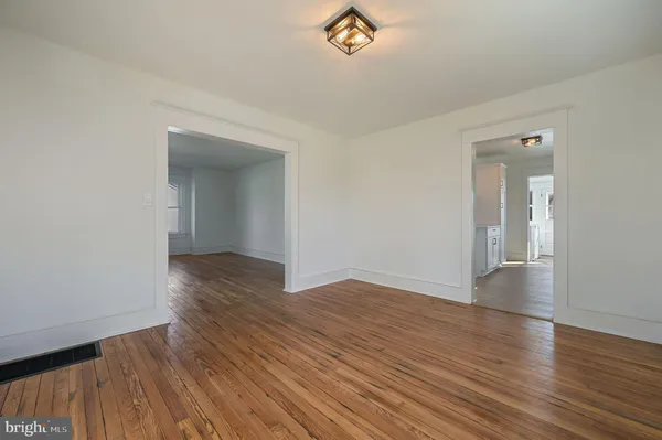 an empty room with wooden floor and closet