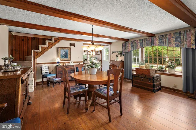 a view of a dining room with furniture and a potted plant