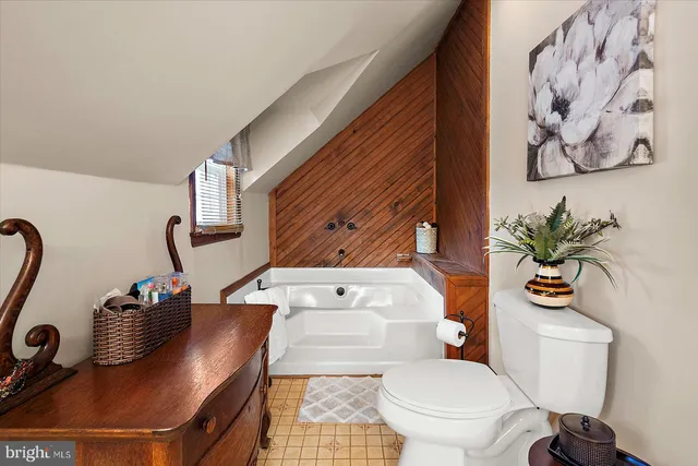 a view of a house with a big yard and large trees