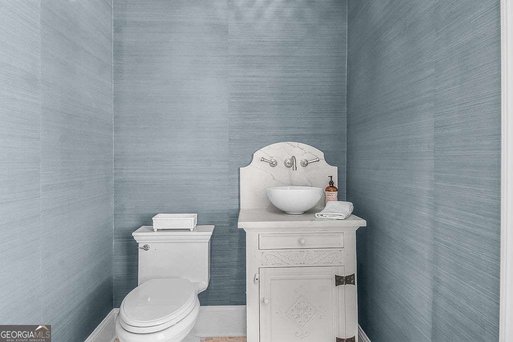 20 Taylor Street Tybee Island, GA 31328 - Photo 45 of 85 a white toilet sitting next to a shower in a bathroom