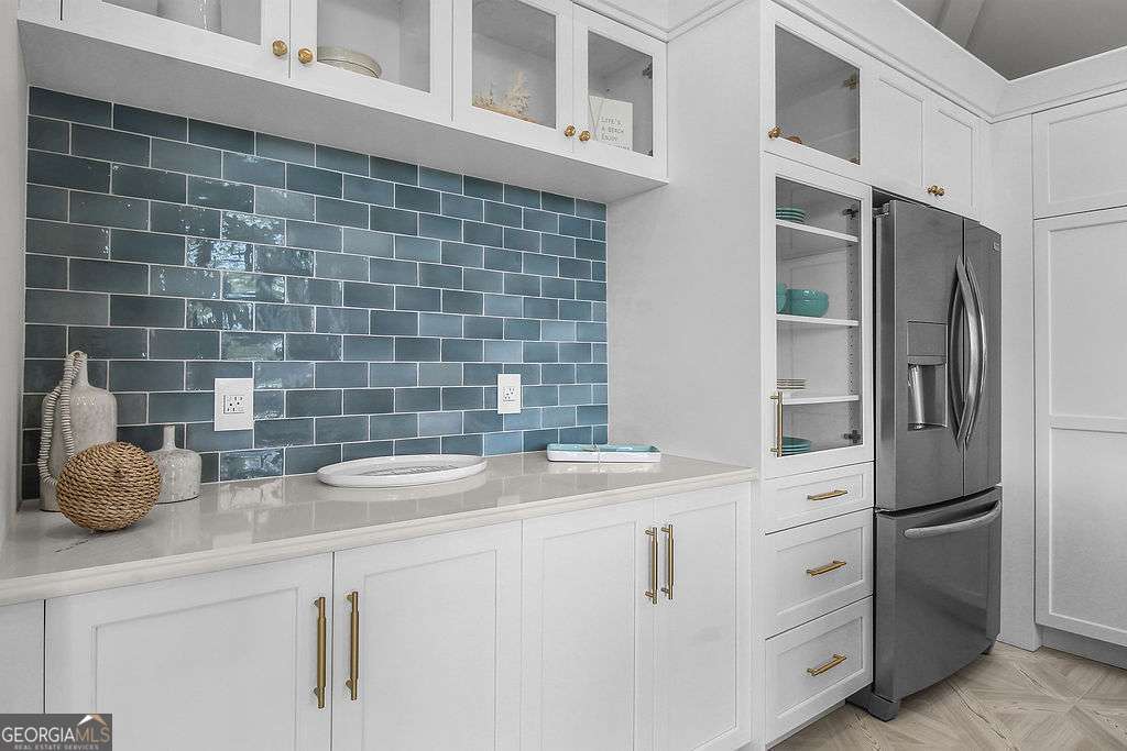 20 Taylor Street Tybee Island, GA 31328 - Photo 49 of 85 a kitchen with a sink and cabinets
