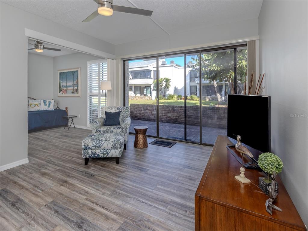 1555 Tarpon Center Drive, Unit 140 Venice, FL 34285 - Photo 12 of 60 a living room with furniture fireplace and a flat screen tv