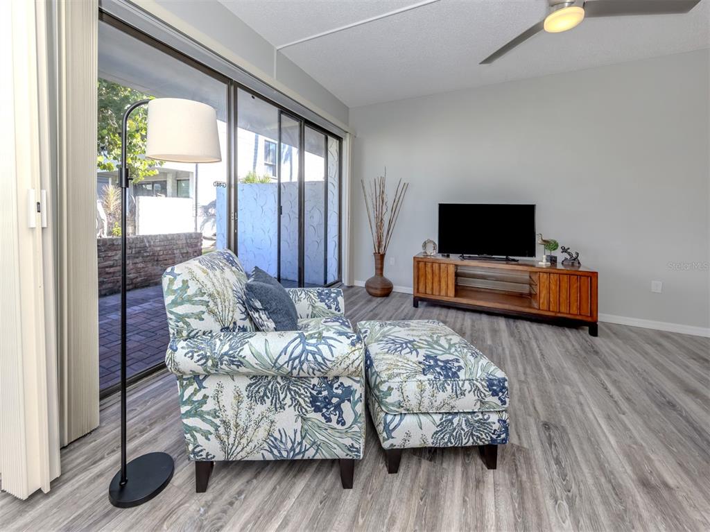 1555 Tarpon Center Drive, Unit 140 Venice, FL 34285 - Photo 14 of 60 a living room with furniture and a flat screen tv