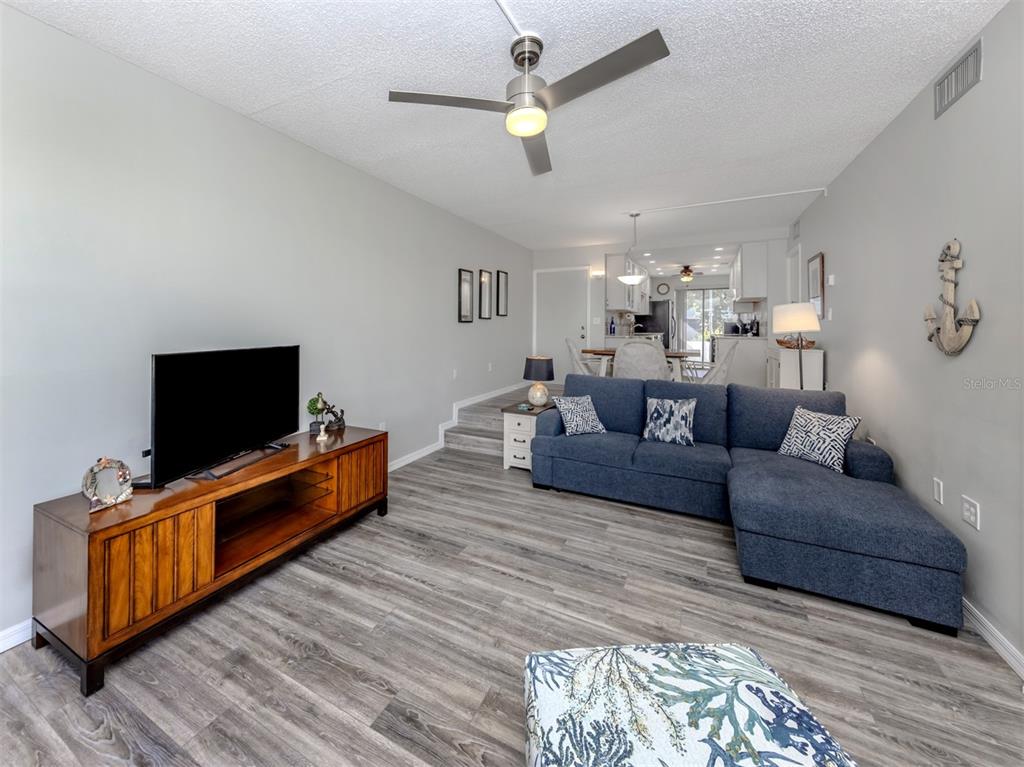 1555 Tarpon Center Drive, Unit 140 Venice, FL 34285 - Photo 15 of 60 a living room with furniture and a flat screen tv