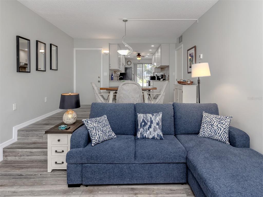 1555 Tarpon Center Drive, Unit 140 Venice, FL 34285 - Photo 17 of 60 a living room with furniture and a lamp