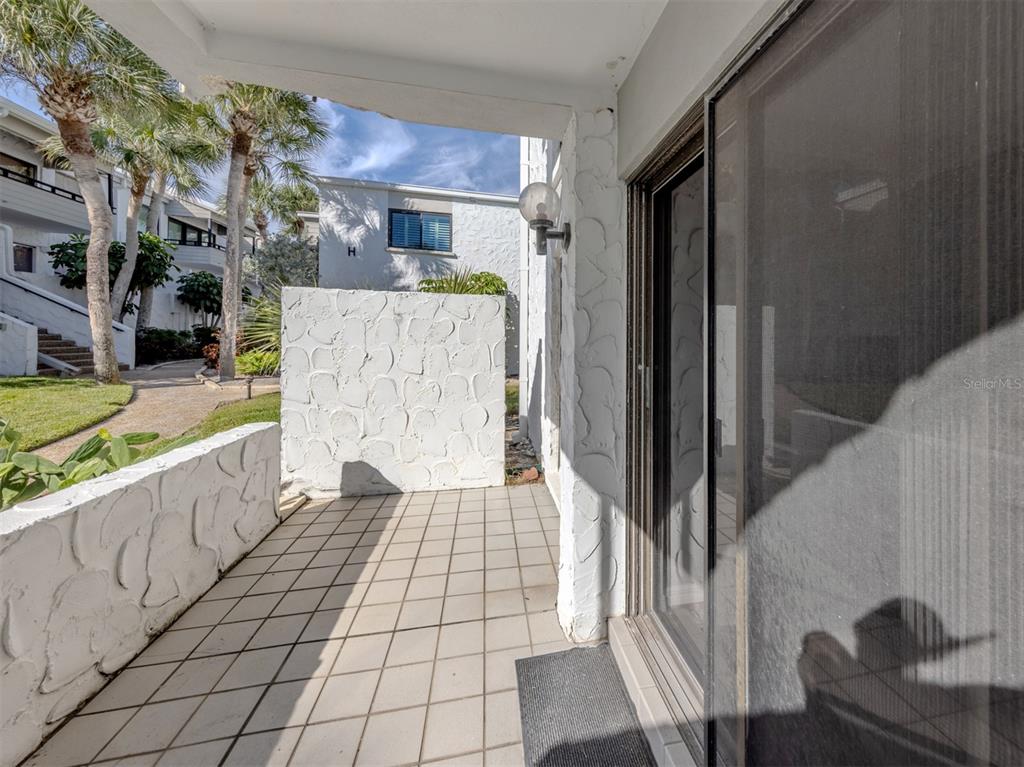 1555 Tarpon Center Drive, Unit 140 Venice, FL 34285 - Photo 18 of 60 a view of a porch with wooden floor and furniture