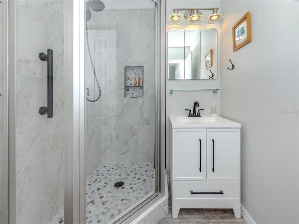 1555 Tarpon Center Drive, Unit 140 Venice, FL 34285 - Photo 24 of 60 a bathroom with a sink a toilet and shower