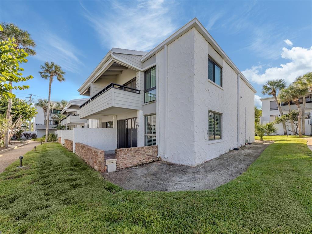 1555 Tarpon Center Drive, Unit 140 Venice, FL 34285 - Photo 28 of 60 a view of a house with a yard and porch