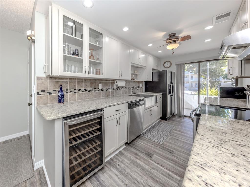 1555 Tarpon Center Drive, Unit 140 Venice, FL 34285 - Photo 6 of 60 a kitchen with stainless steel appliances a sink stove and cabinets