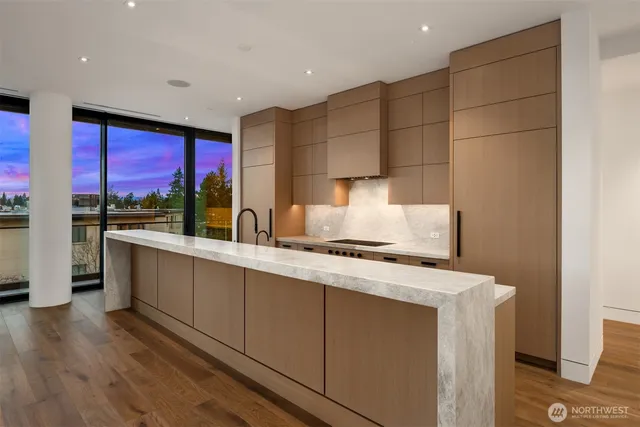 a kitchen with a sink cabinets and wooden floor