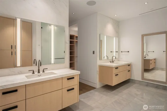 a bathroom with double vanity sink and mirror