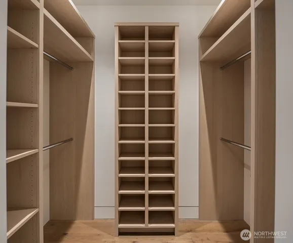 a view of walk in closet with empty racks