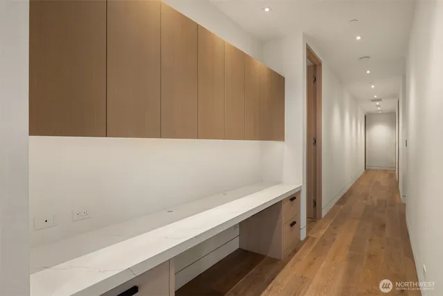 a view of a hallway with wooden floor