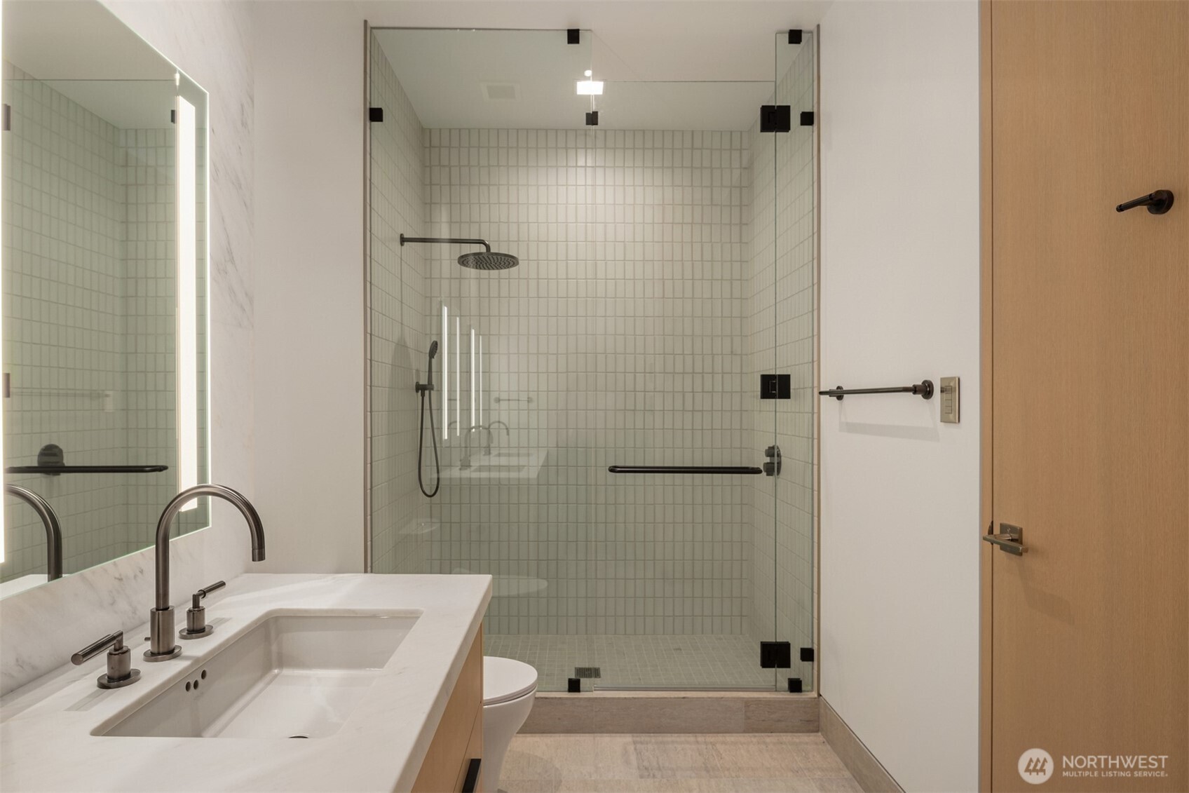 8 100th Avenue Northeast, Unit 201 Bellevue, WA 98004 - Photo 22 of 35 a bathroom with a sink a toilet and shower