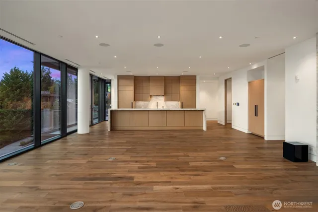 a living room with stainless steel appliances kitchen island furniture and wooden floor