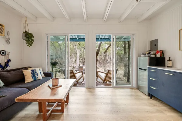 a living room with furniture and a floor to ceiling window