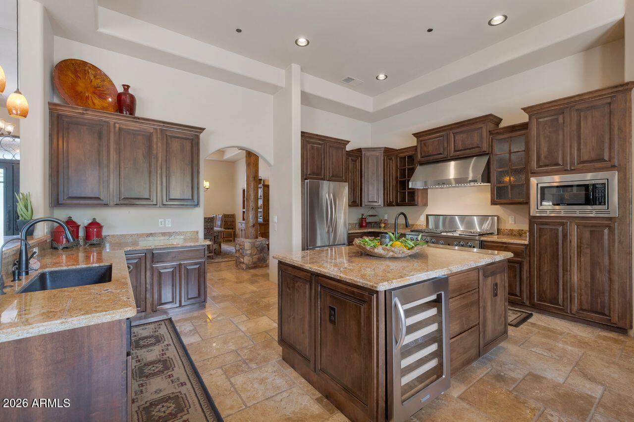 18507 East Picacho Road Rio Verde, AZ 85263 - Photo 6 of 33 a kitchen with stainless steel appliances granite countertop a stove oven and a refrigerator