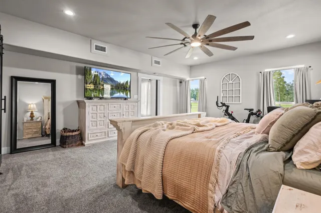 a bed room with a bed and a mirror