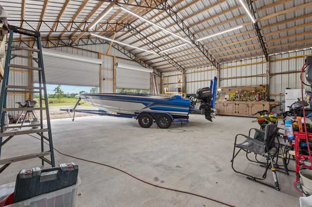 a view of a patio with a table chairs and a floor to ceiling window next to a yard