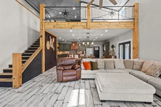 a living room with furniture and a chandelier