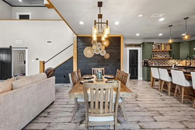 a living room with fireplace furniture and a chandelier