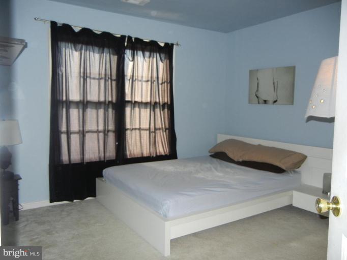 6568 Forsythia Street Springfield, VA 22150 - Photo 14 of 15 a bedroom with a bed and a window