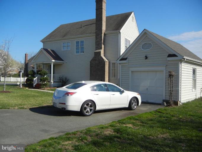 6568 Forsythia Street Springfield, VA 22150 - Photo 6 of 15 a white house covered with tall trees