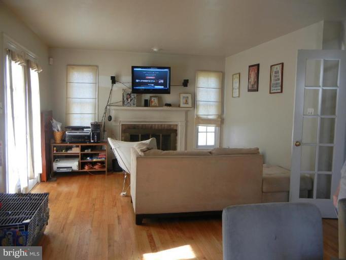 6568 Forsythia Street Springfield, VA 22150 - Photo 8 of 15 a living room with furniture and a flat screen tv