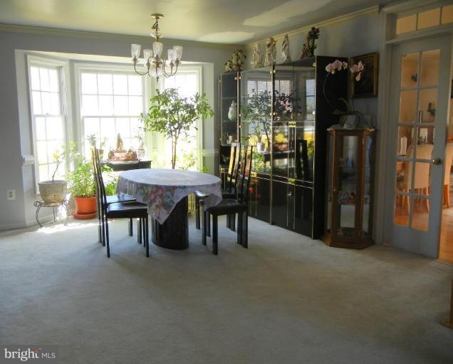 6568 Forsythia Street Springfield, VA 22150 - Photo 9 of 15 a view of a dining room with furniture and chandelier