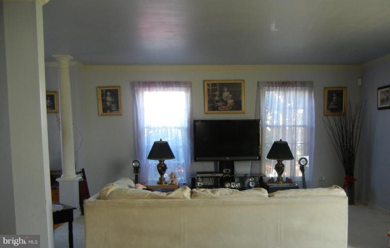 6568 Forsythia Street Springfield, VA 22150 - Photo 10 of 15 a room with furniture and a flat screen tv