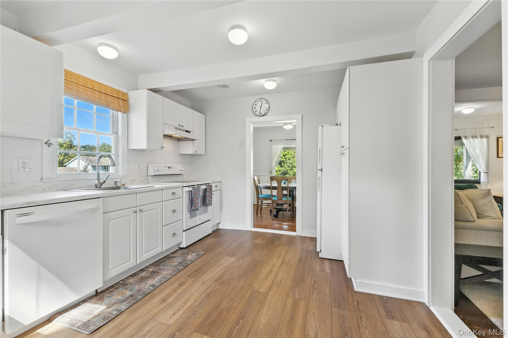 168 Gleneida Ridge Road Carmel, NY 10512 - Photo 17 of 48 a kitchen with white cabinets and wooden floor
