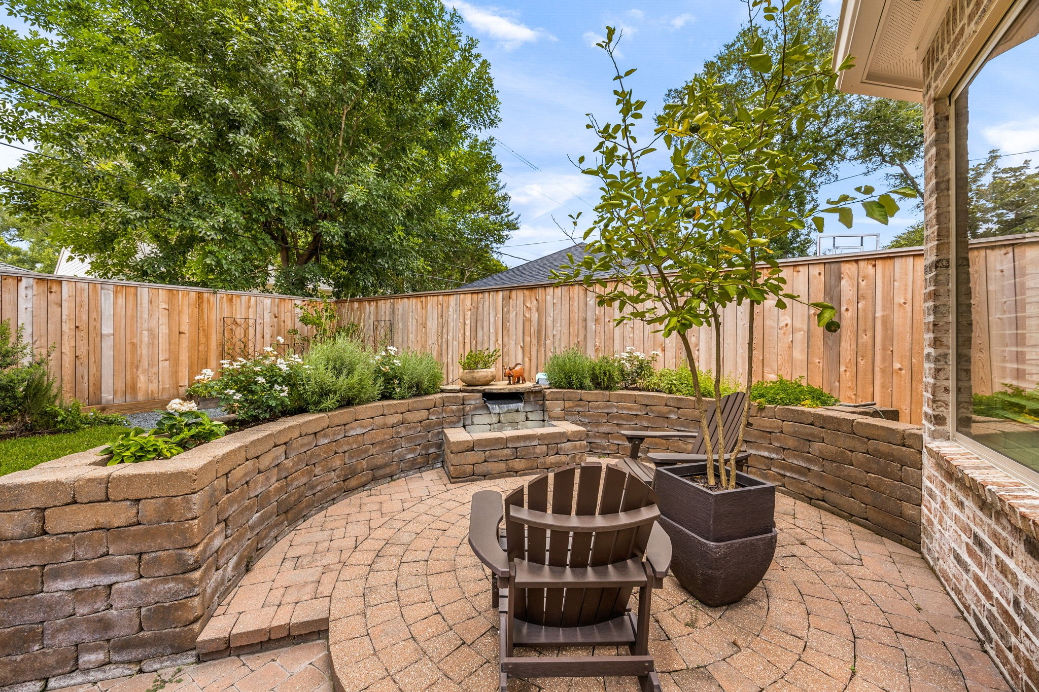 13310 Apple Tree Road Houston, TX 77079 - Photo 40 of 50 Just outside of the Primary bedroom is a beautiful water feature and seating area, overlooking the raised gardens full of fresh herbs.