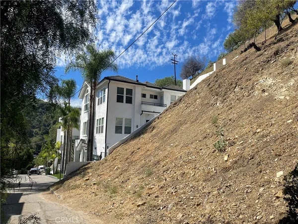 a view of a house with a large tree