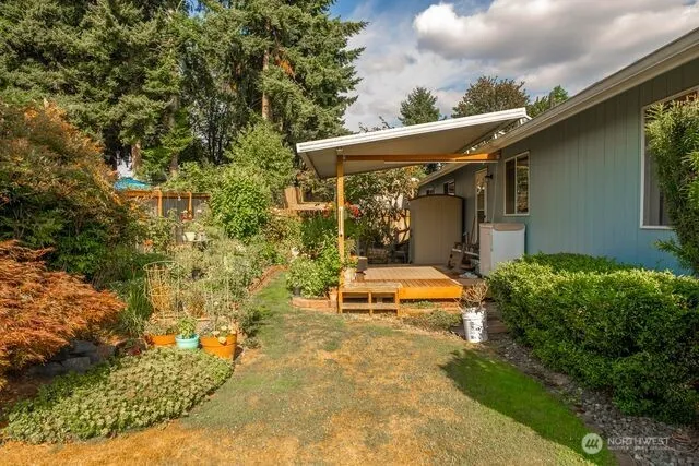 a view of a patio with table and chairs and potted plants
