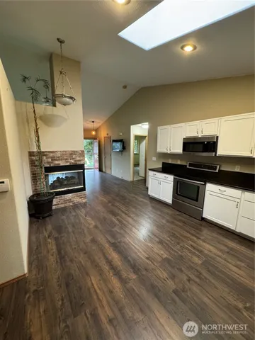 a view of a kitchen with a sink and a stove top oven