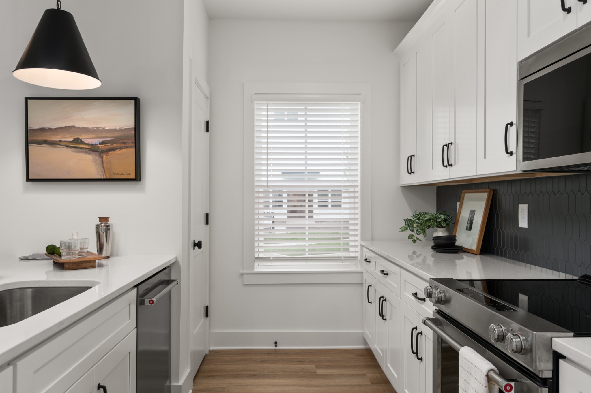 320 Mullberry Terrace, Unit A Madison, TN 37115 - Photo 7 of 26 a kitchen with stainless steel appliances granite countertop a sink a stove and a microwave